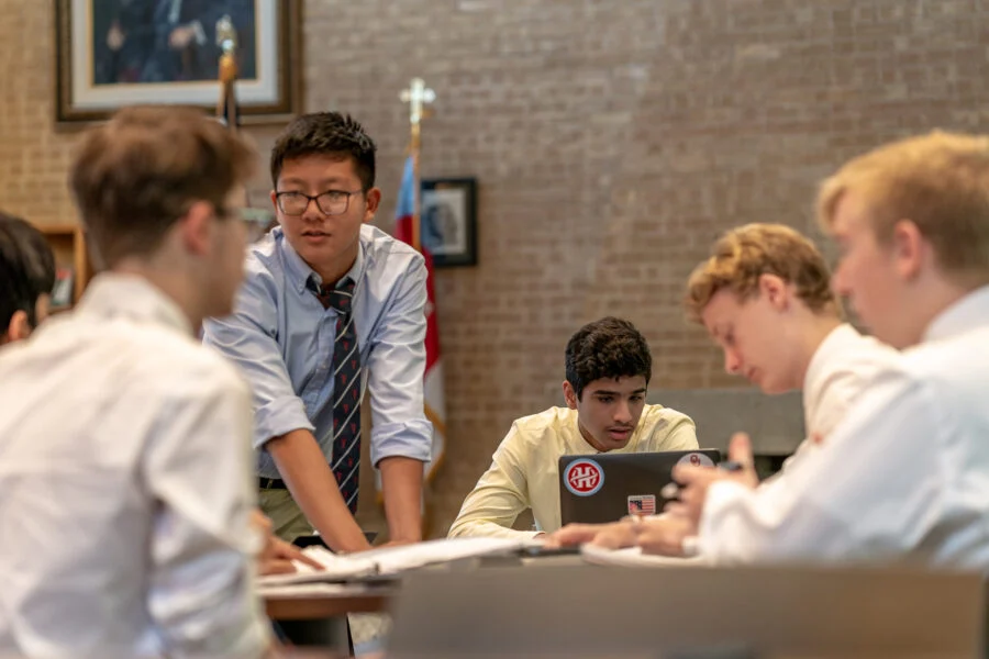 Students in a group learning session in the Upper School Library.