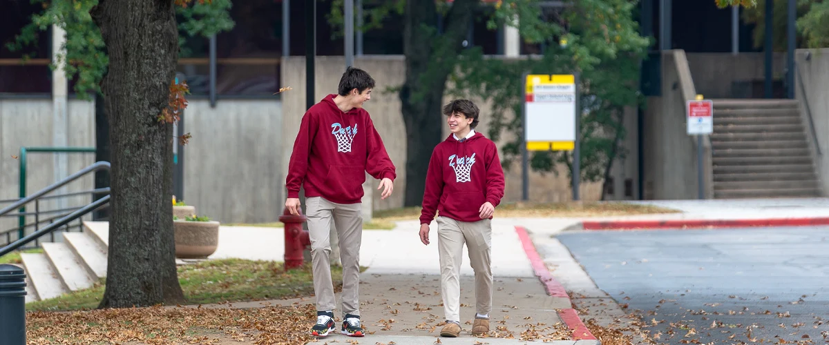 Two student walking and talking on Holland Hall Episcopal school's campus