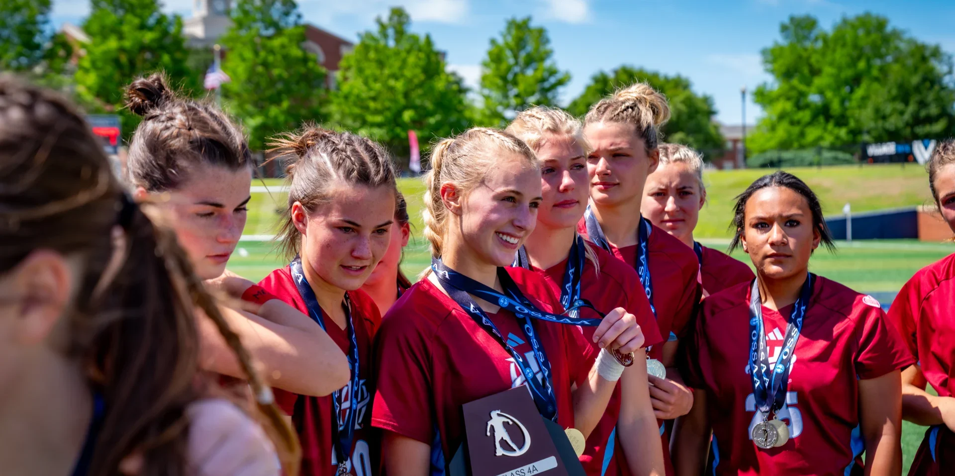 Holland Hall athletics program girls soccer state champions celebrating with championship medals